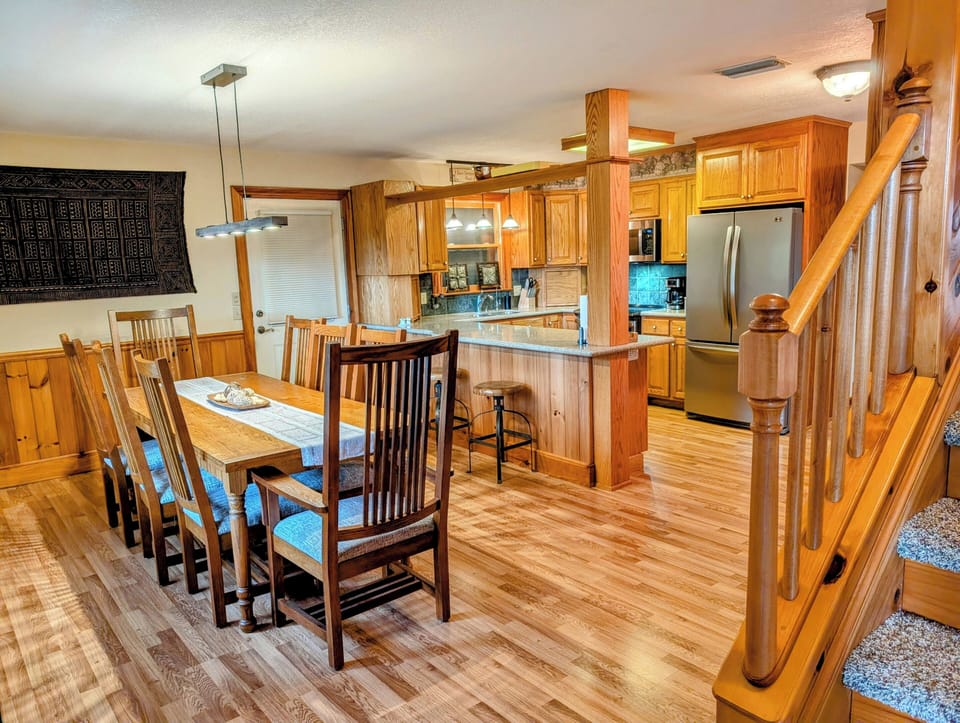 The dining room table seats 8 + 2 additional bar stools