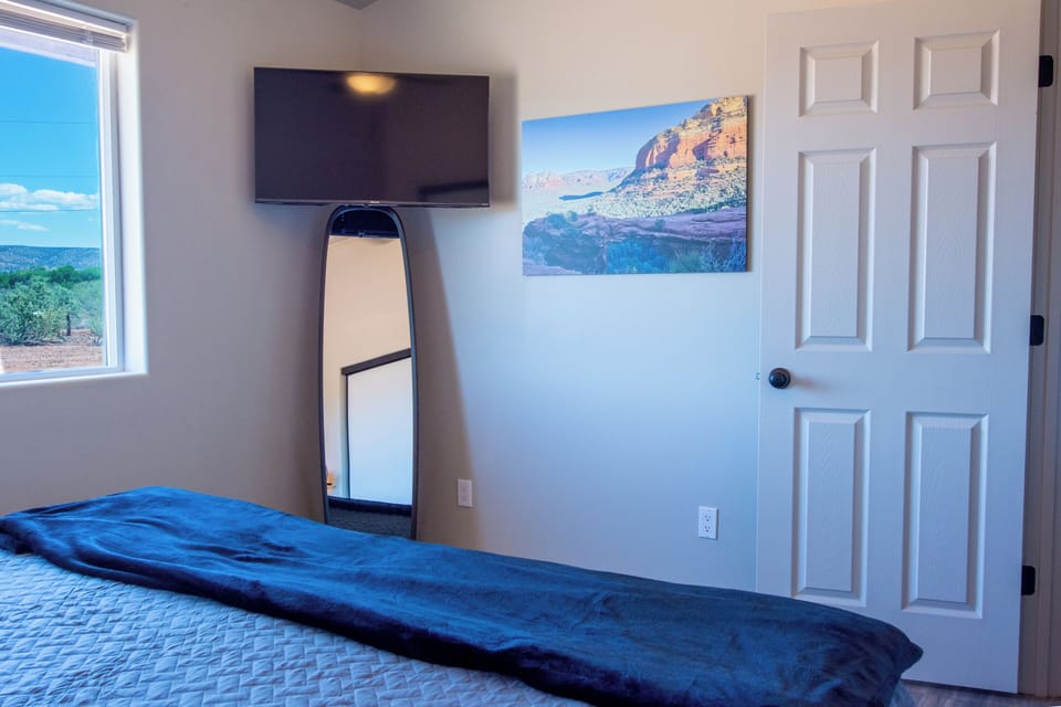 Bedroom with smart TV and local art