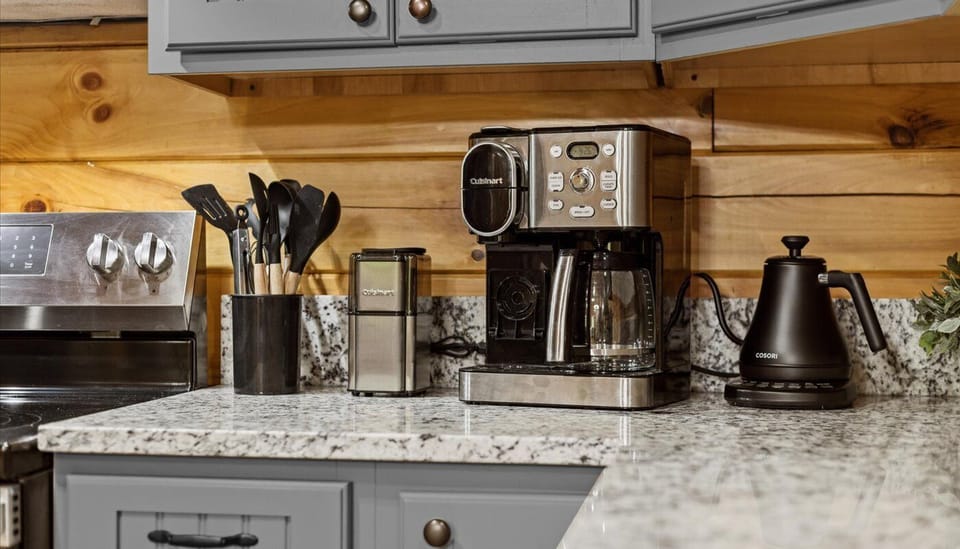 The modern kitchen is fully equipped with everything you need to cook delicious meals during your stay. Our beverage area has a Cuisinart coffee maker for K-cups or grinds no filter needed. We also have a Cuisinart coffee grinder and a tea kettle.