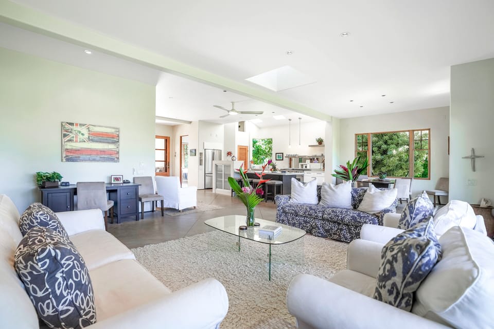 Living room seating with open kitchen view and work desk and extra seating Too.