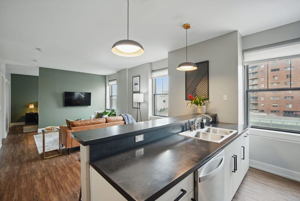 Enjoy cooking with a view in this bright and modern kitchen, complete with dual sinks, stylish lighting, and plenty of prep space.