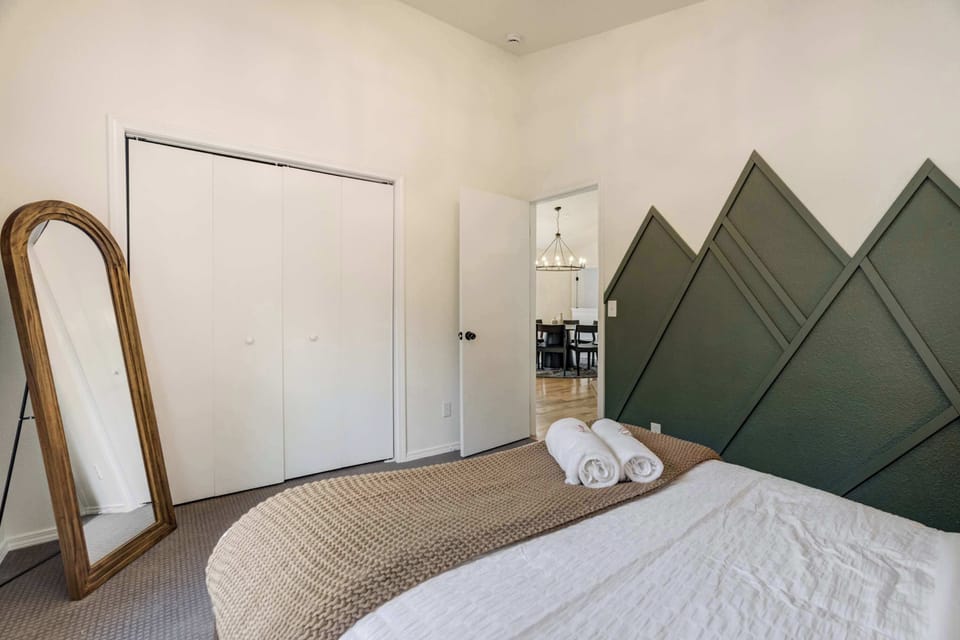 This queen bedroom includes a full closet, mountain-inspired design, and easy access to the main living space.

