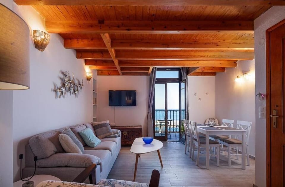 Relax in the living room while taking in the mesmerizing blue sea