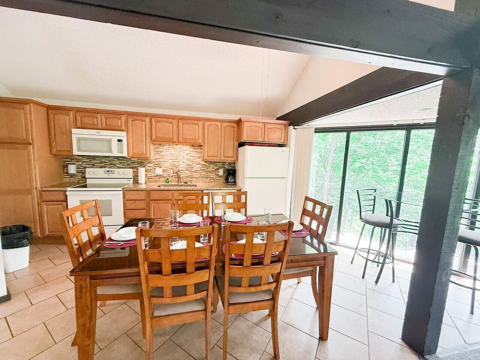 Dine with a view! This charming table offers a front row seat to the tranquil wooded surroundings.
