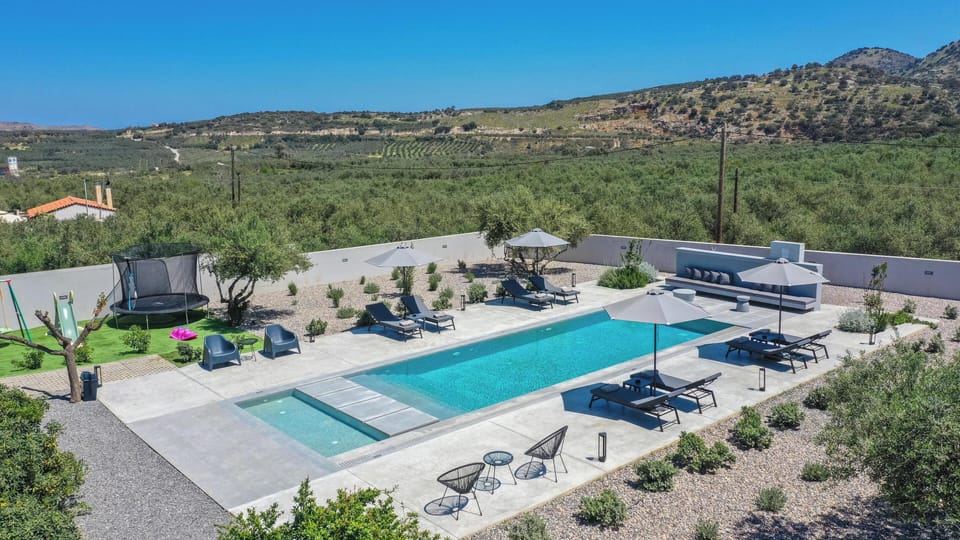 The private heated pool takes center stage among peaceful countryside surroundin