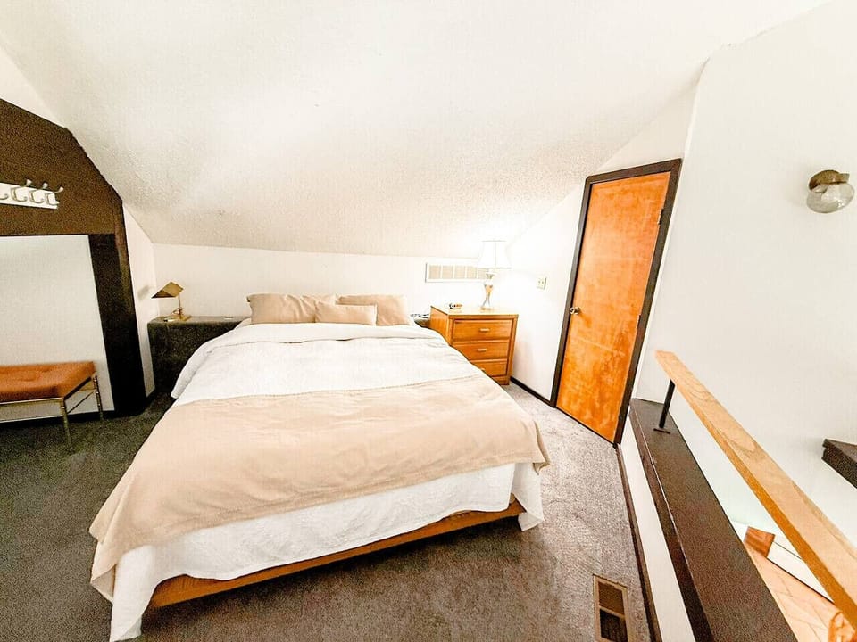 A quiet bedroom retreat with a comfortable bed, soft lighting, and a calming atmosphere, designed for restful nights