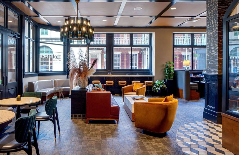 Modern lounge with comfy chairs and large street-facing windows