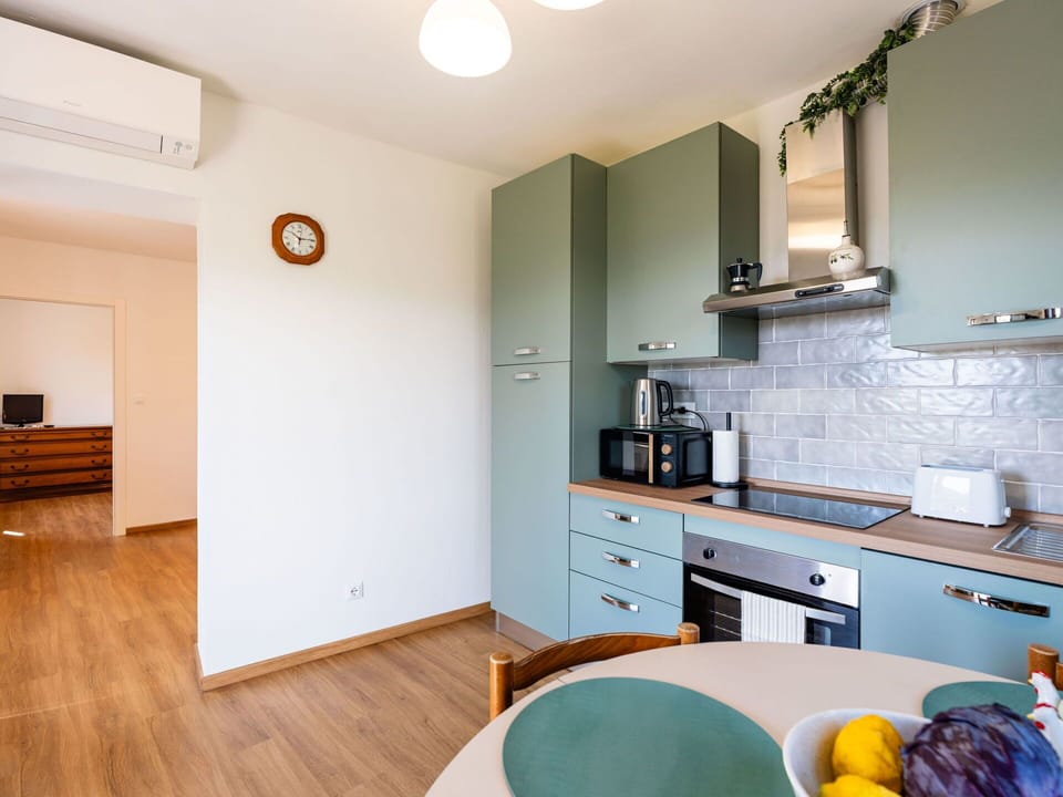 Kitchen, Interior Design, Kitchen Appliance, Flooring, Countertop, Major Appliance, Furniture, Cabinetry, Wood, Floor