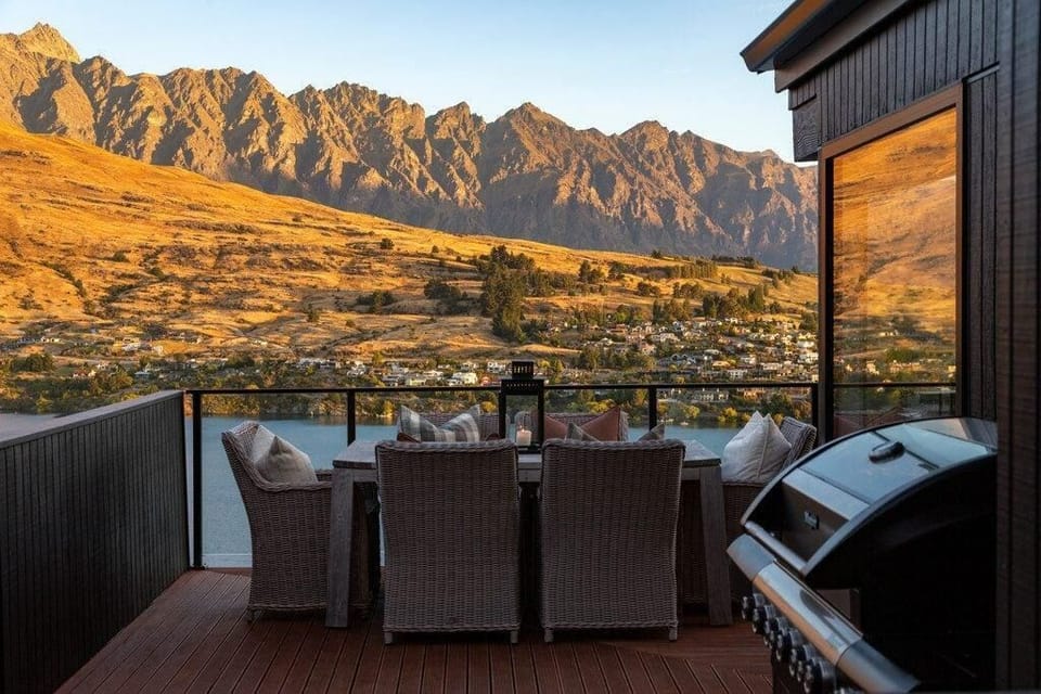 Modern outdoor dining with stunning lake and mountain views.