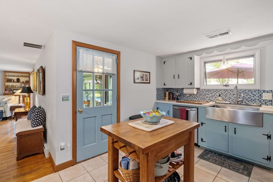A welcoming side door brings in natural light and easy access to the sun porch—perfect for enjoying a quick step outside with your coffee.
