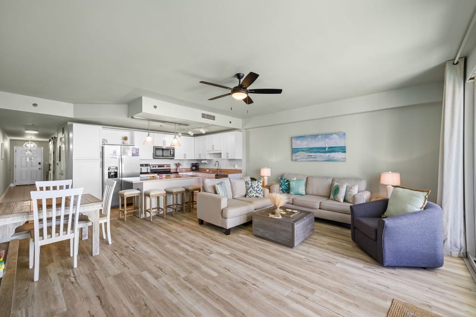 Open-concept living area with modern kitchen and coastal-inspired decor.