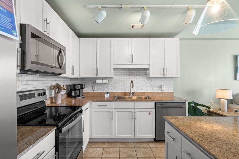 Modern kitchen with white cabinetry and stainless steel appliances
