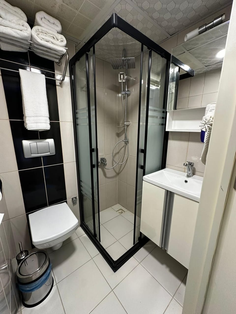 Shower, hair dryer, slippers, towels