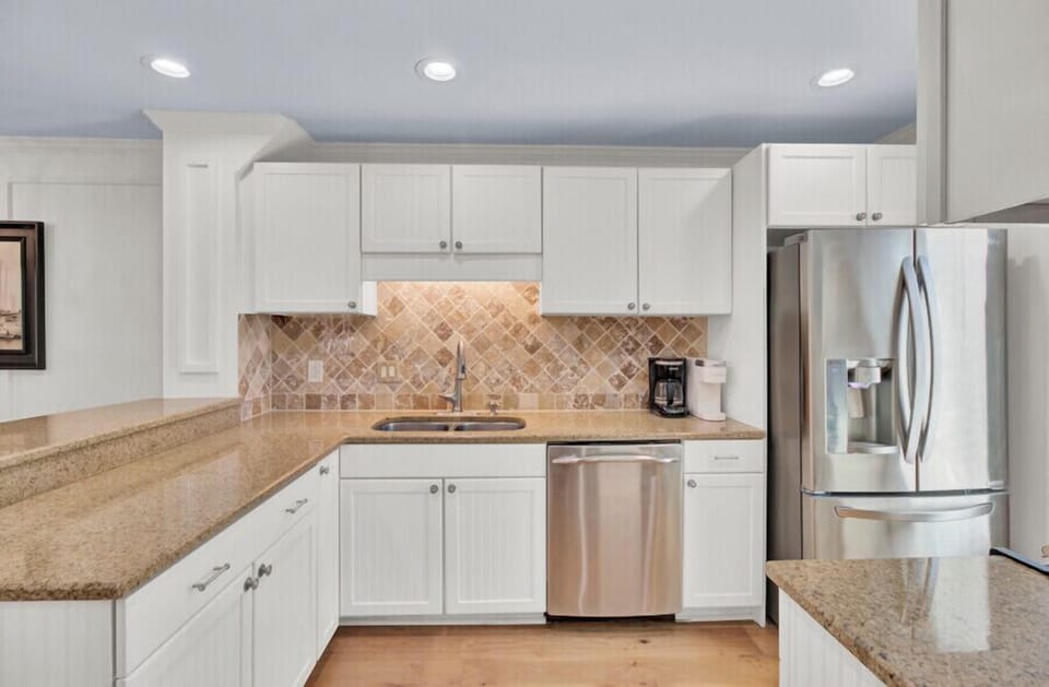 Your well-equipped kitchen features stainless steel appliances, granite countertops, and a decorative tile backsplash—perfect for preparing home-cooked meals during your stay.
