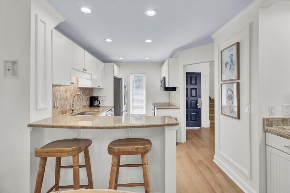 Your bright, fully equipped kitchen invites you to prepare meals with ease. Granite counters, modern appliances, and a cozy breakfast bar make this space both functional and welcoming.