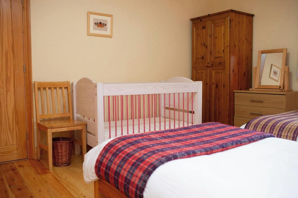 Twin bedroom with full size cot, dressing table and wardrobe
