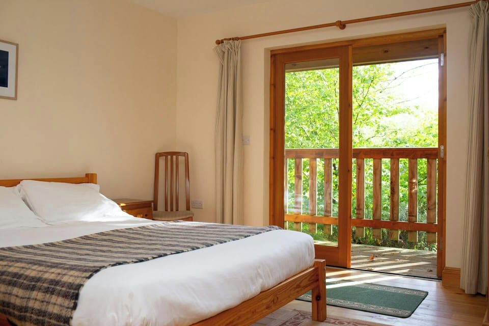 Kingside bed with bedside tables and views over the countryside