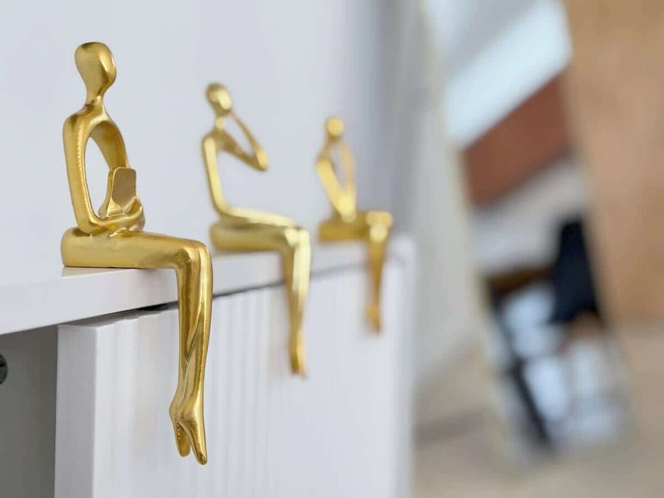 Modern golden sculptures add a stylish and artistic touch—simple yet elegant décor that elevates the space.