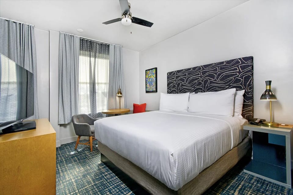 Unwind in crisp linens and a calming, modern bedroom.