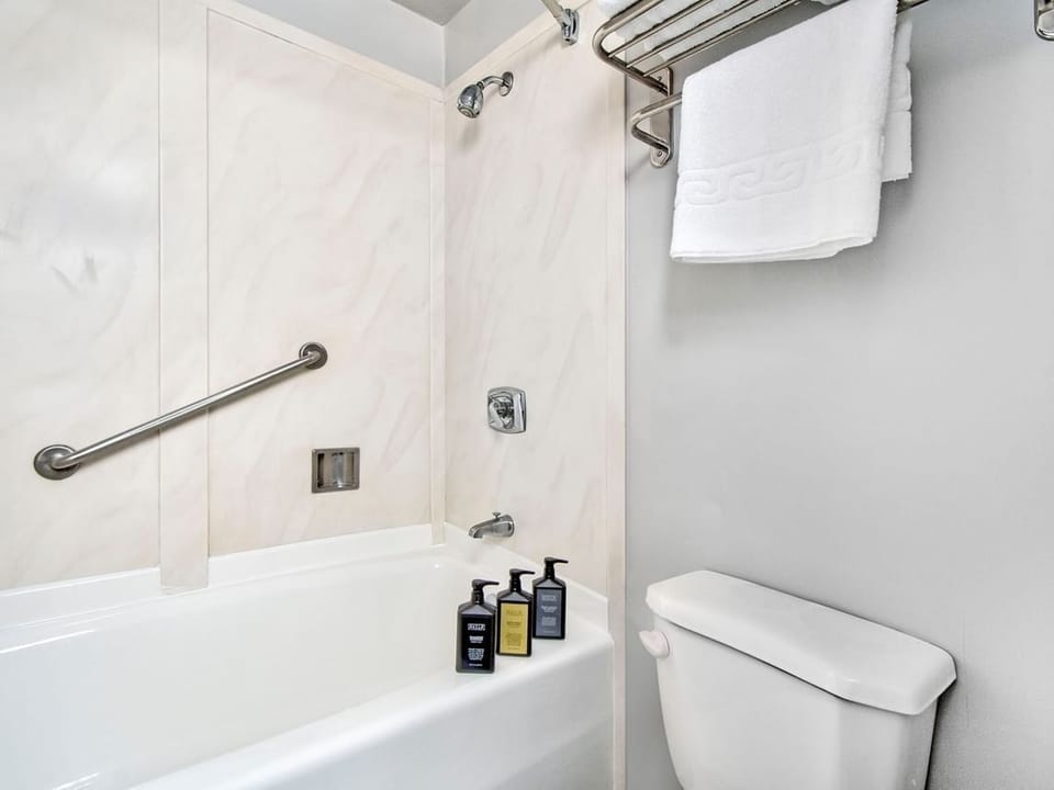 Relax with a hot shower in a spotless, simple bath.
