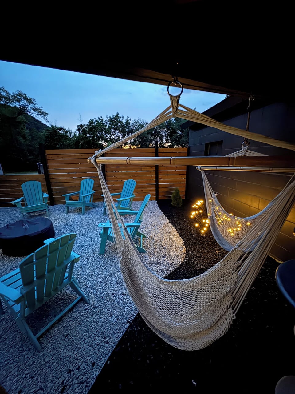 Private fenced in Outdoor gas fire pit, hammock swings and gas grill with patio dining.