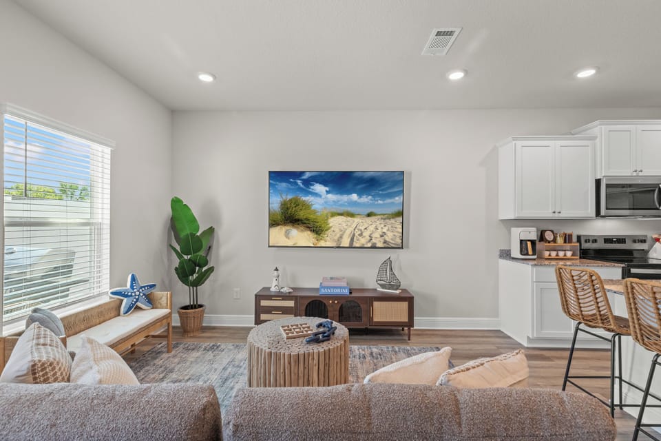 Unwind in the cozy living room with a plush couch, bench seating, and Smart TV