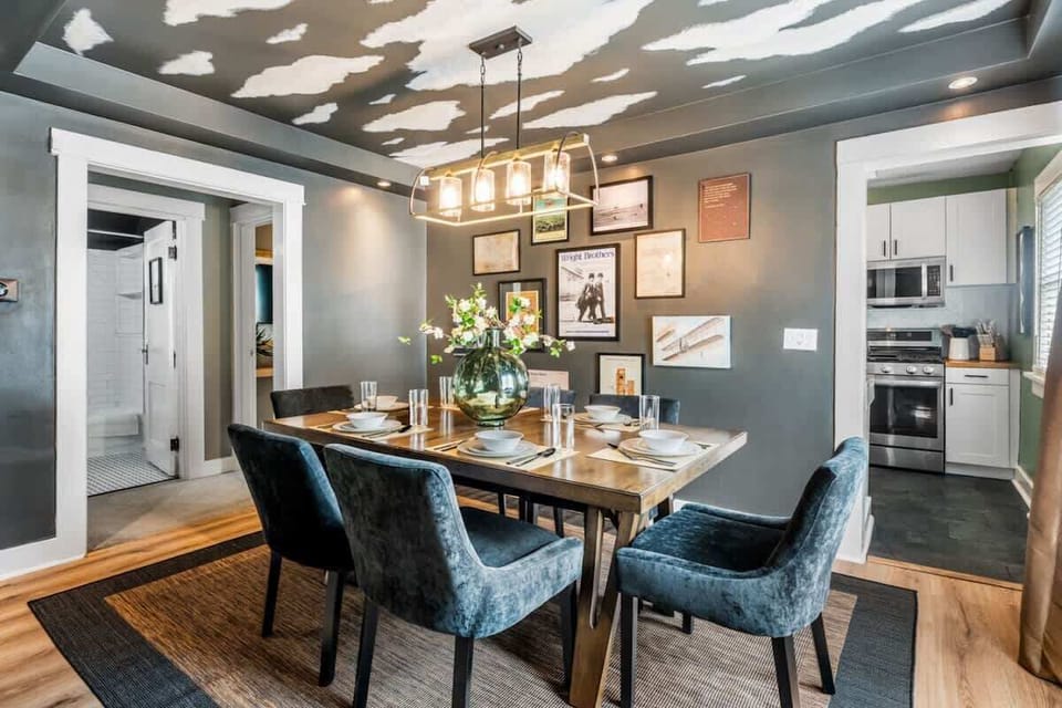 Dining area w/ a sleek table & modern lighting, perfect for shared meals and lively conversations