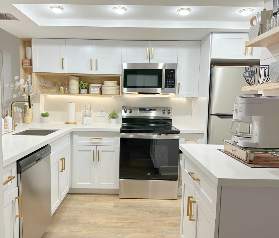 [Kitchen] Fully stocked chef's kitchen. Wine refrigerator right of stove. 