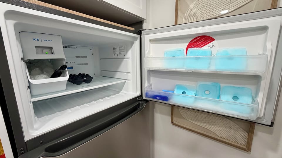 Freezer equipped with ice machine and ice packs for coolers for the beach.