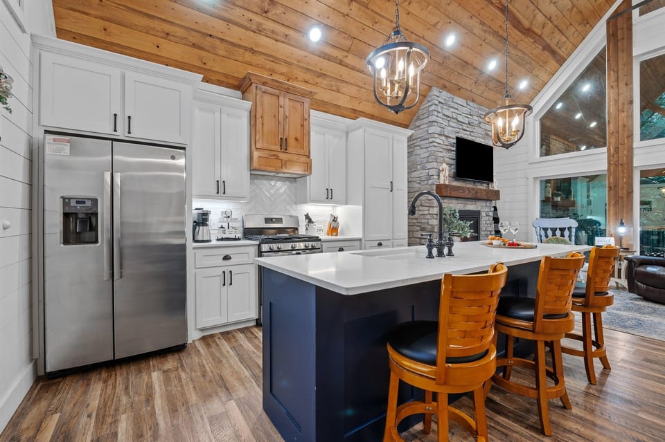 This stylish kitchen blends modern convenience with rustic elegance—perfect for memorable meals and fireside chats.