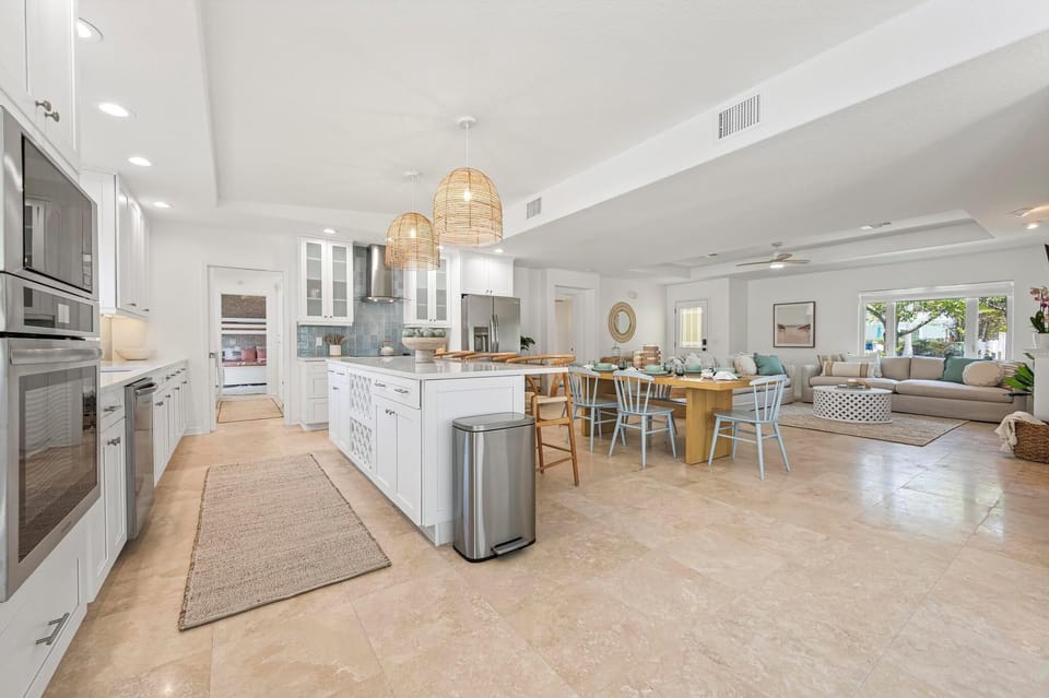 Tons of natural lighting flood living, dining, and kitchen area