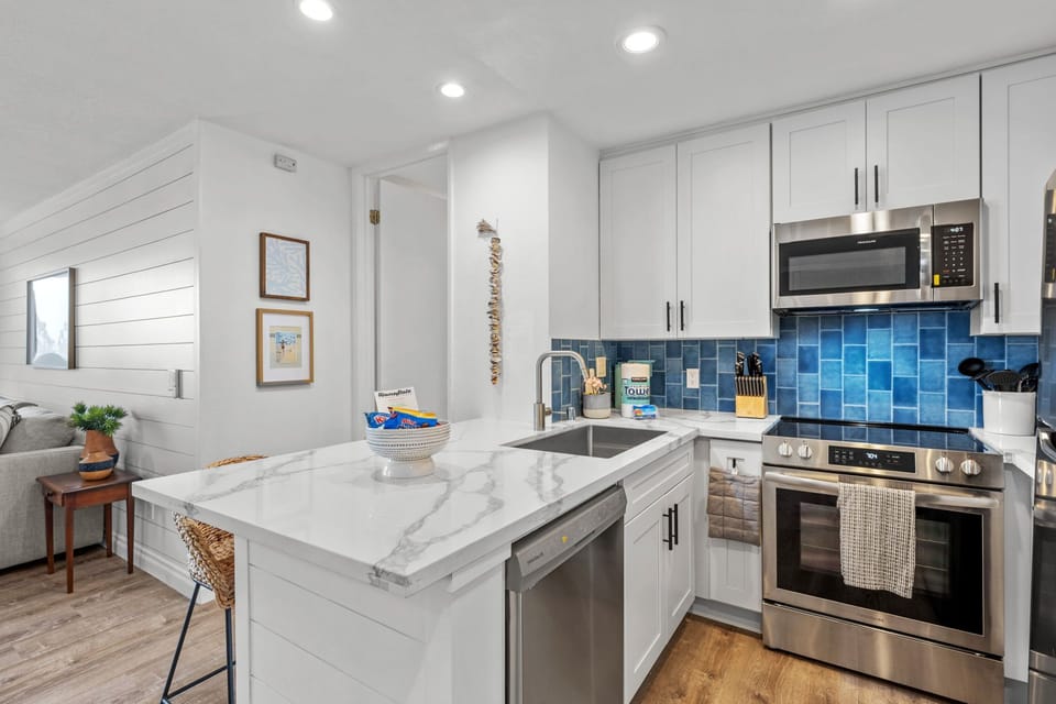 A beautiful, fully equipped kitchen featuring everything you need for your vacation meals, complete with new countertops and updated cabinets.