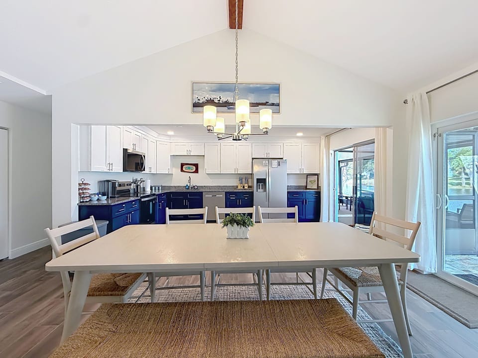 Dining table for 8 with views of river, between living room and large kitchen.