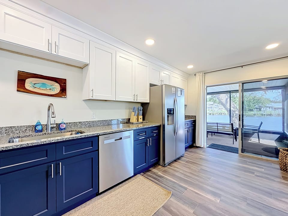 view of kitchen which leads to patio and to pool area, great views of river.