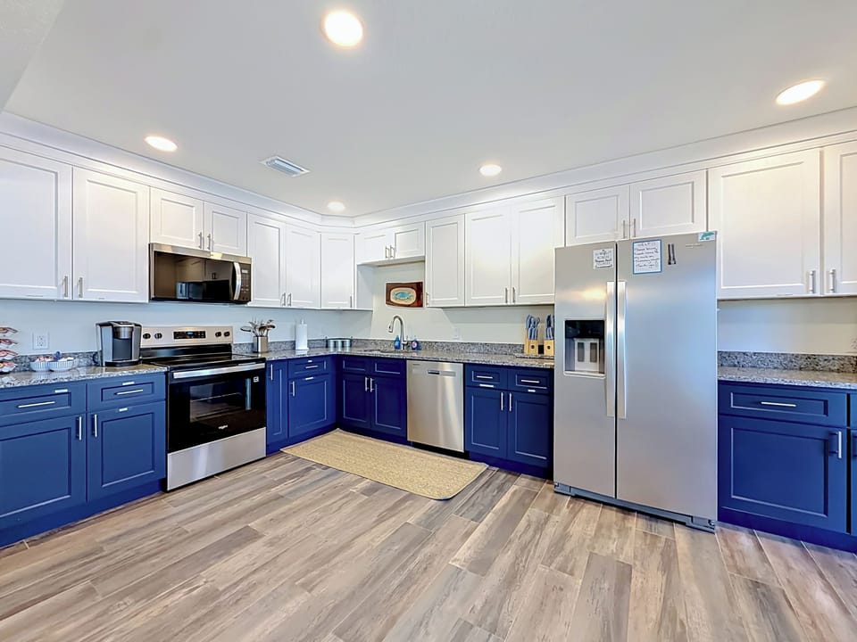Full large kitchen with plenty of space for prepping meals with a coffee area. 