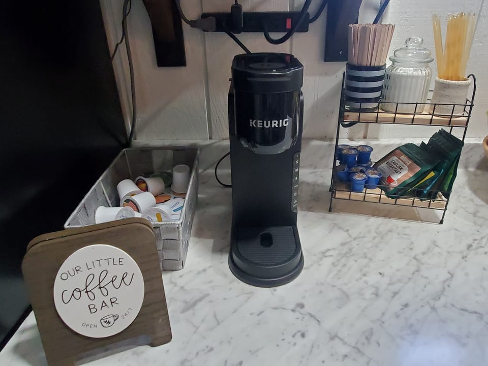 keurig w/coffee pods, tea bags, creamers, sugar, stirring sticks