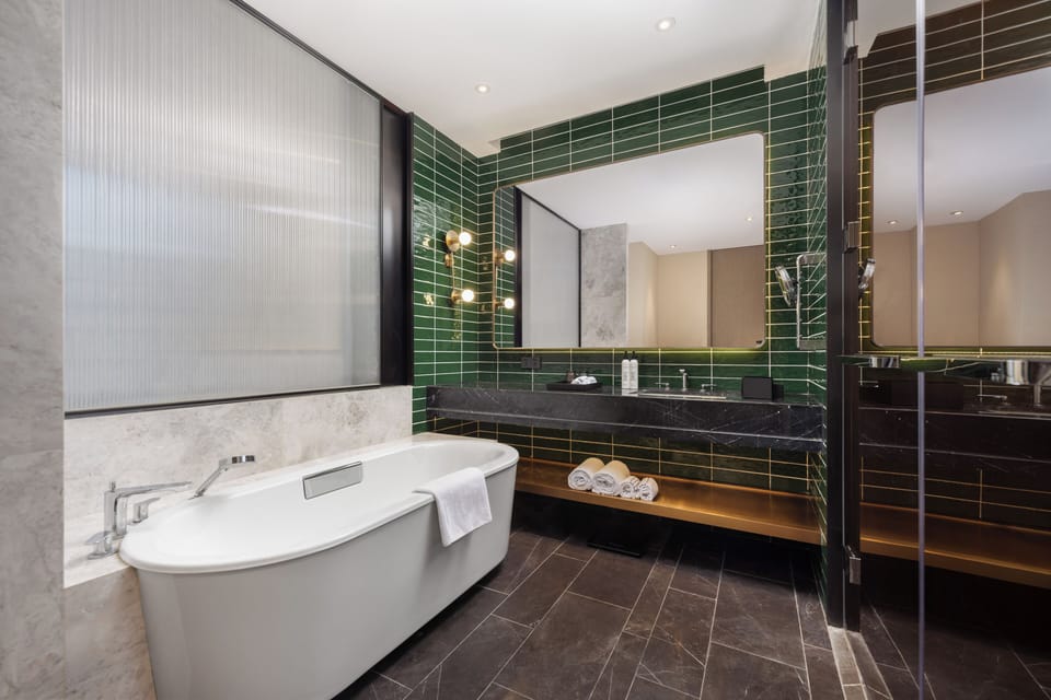 Moment Suites | Bathroom | Shower, hair dryer, towels, shampoo