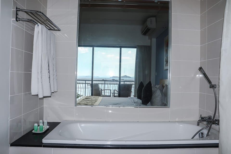 Deluxe Double or Twin Room, Sea View | Bathroom | Rainfall showerhead, hair dryer (on request), towels, soap