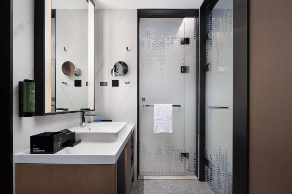Shower, hair dryer, slippers, towels