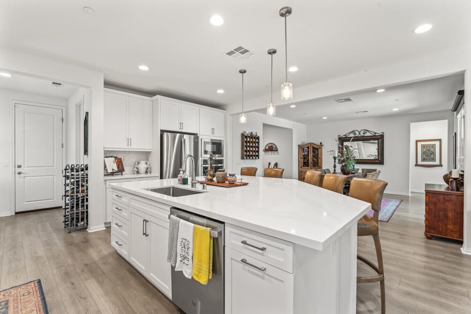 Bright kitchen w/ large island, pendant lighting & plenty of prep space