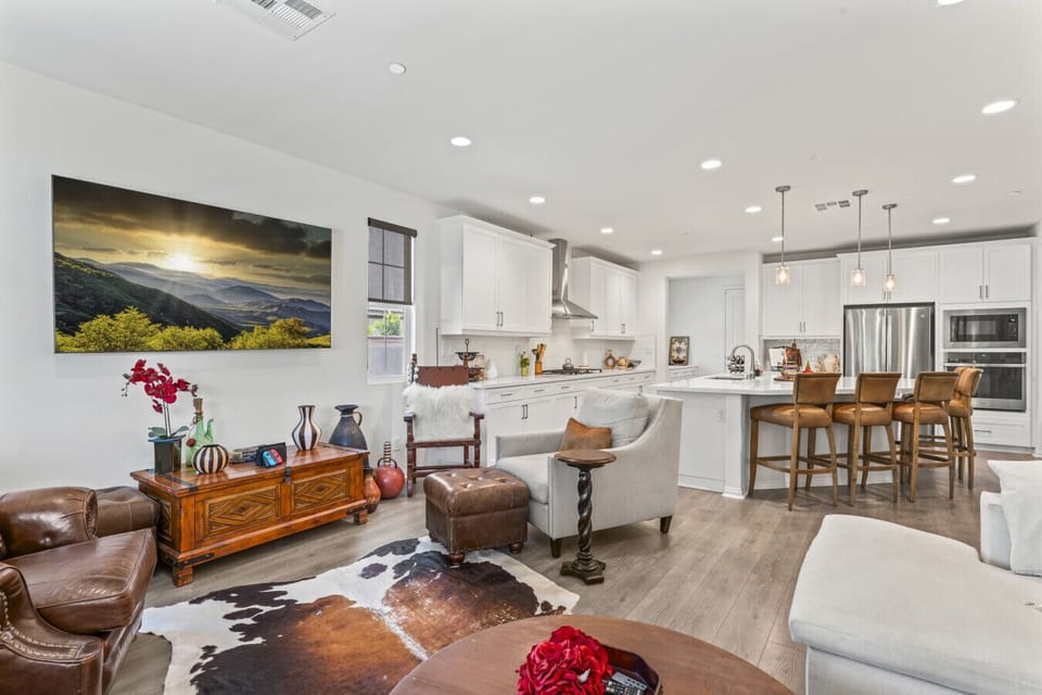 Open living area flowing into kitchen w/ island seating, great for socializing indoors