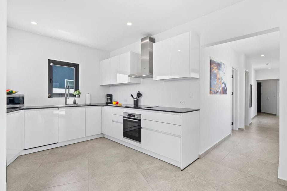 Modern kitchen with glossy finishes and full cooking setup