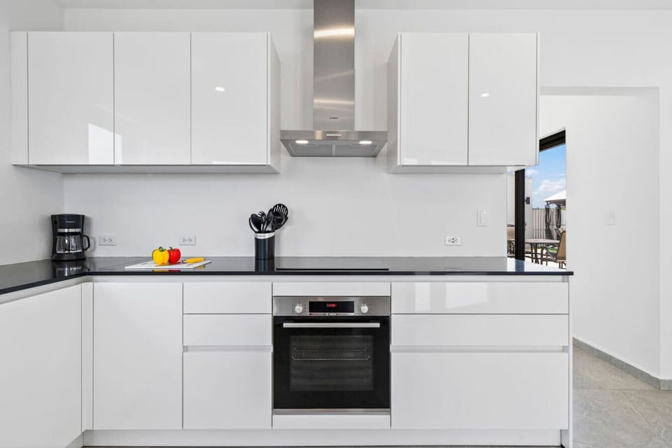 Stocked chef’s kitchen with stainless appliances & sleek cabinetry.