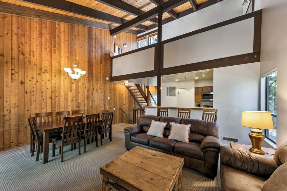 Relax in this stunning loft with exposed beams, cozy leather seating, and an open dining area perfect for gathering.