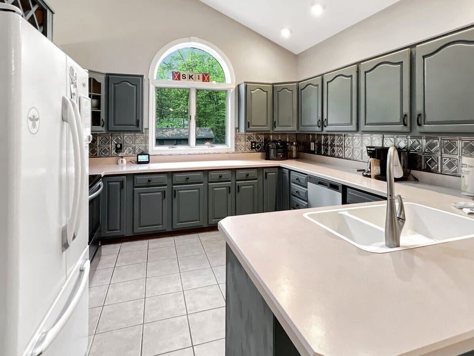 Large kitchen with glass top electric stove  dishwasher, full size refrigerator,