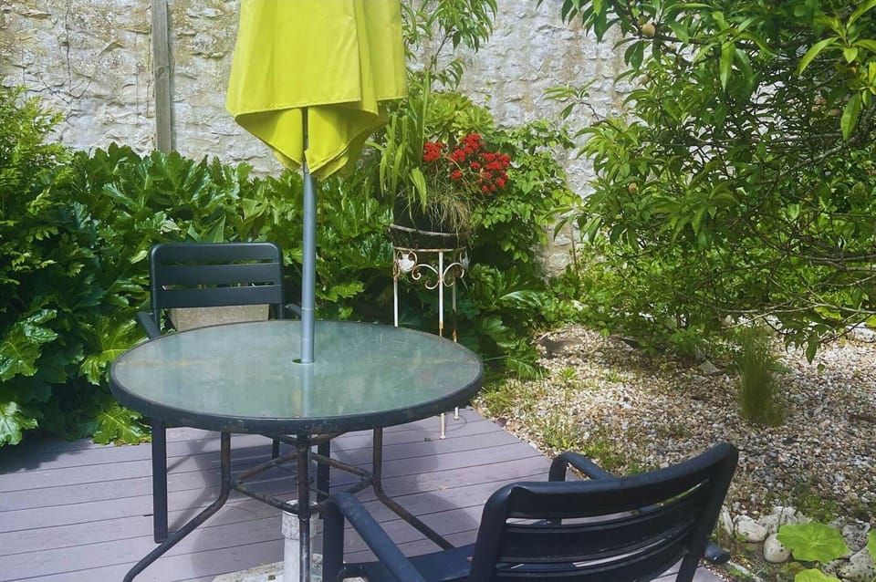 Terrasse fleurie et calme pour vos repas à l’extérieur Entouré de plantes luxuriantes et de murets en pierre, ce petit coin repas est idéal pour savourer l’ambiance douce et typique de l’île de Ré.