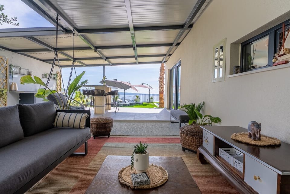 A spacious, seaview terrace where the shaded lounge area opens up to a breathtaking horizon.