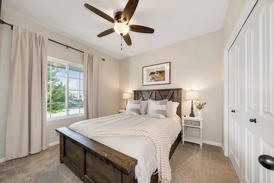 Unwind in your serene bedroom sanctuary with plush linens and gentle ceiling fan keeping you comfortable all night.