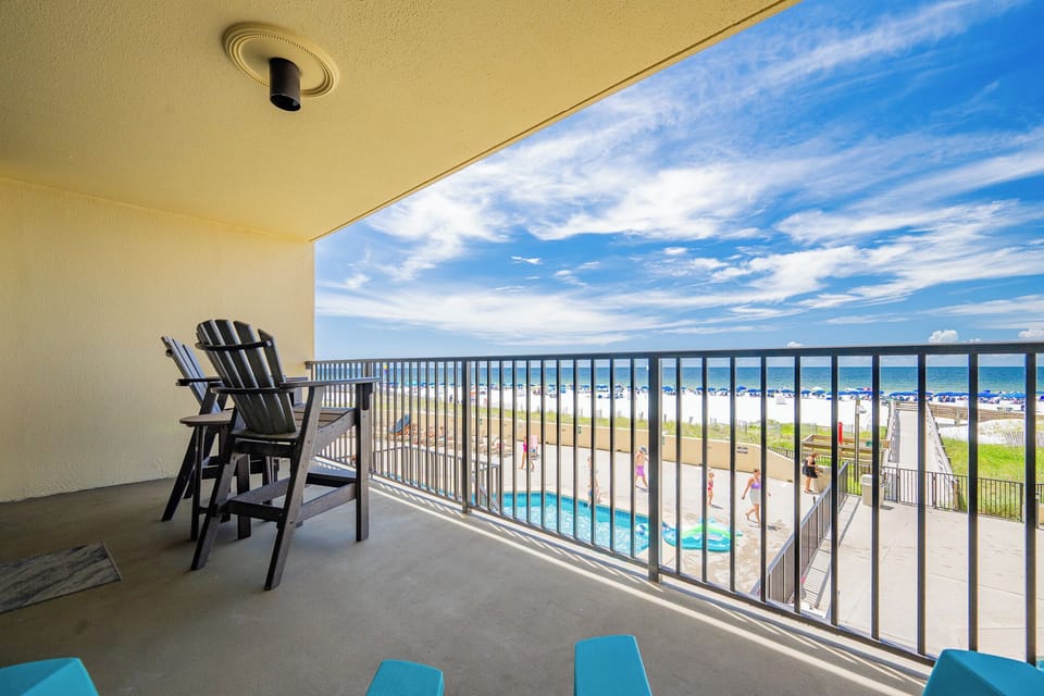 Relax on the balcony with stunning views of the beach and pool, perfect for enjoying sunny days by the water