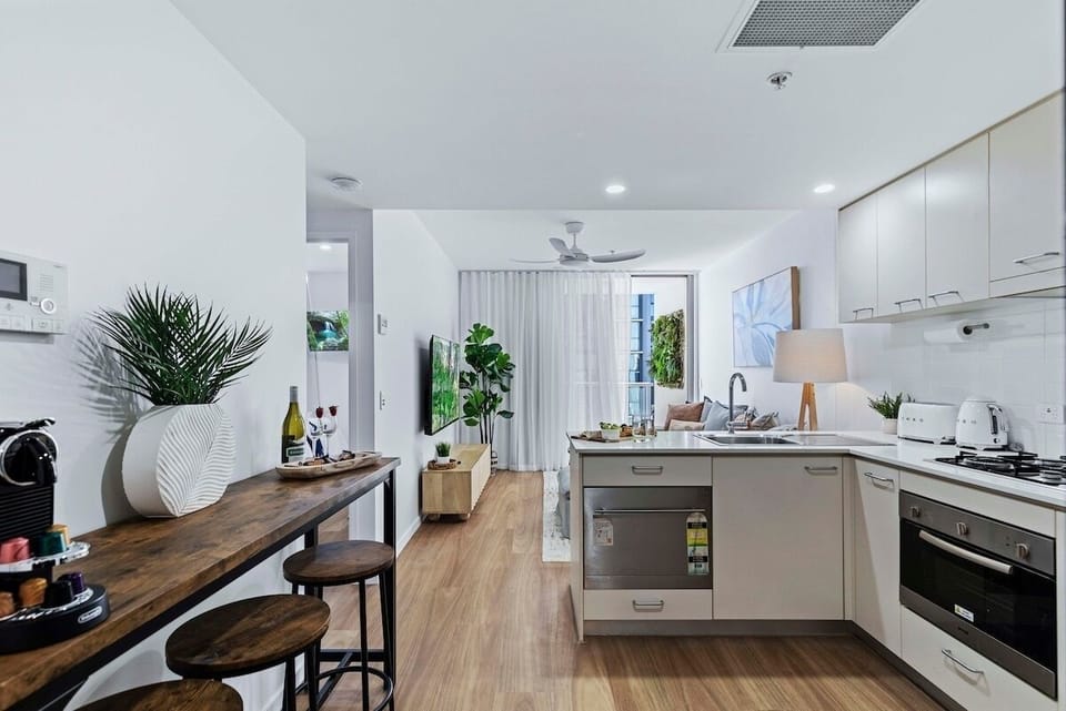 View from entrance through open-plan kitchen with bar dining to lounge with view